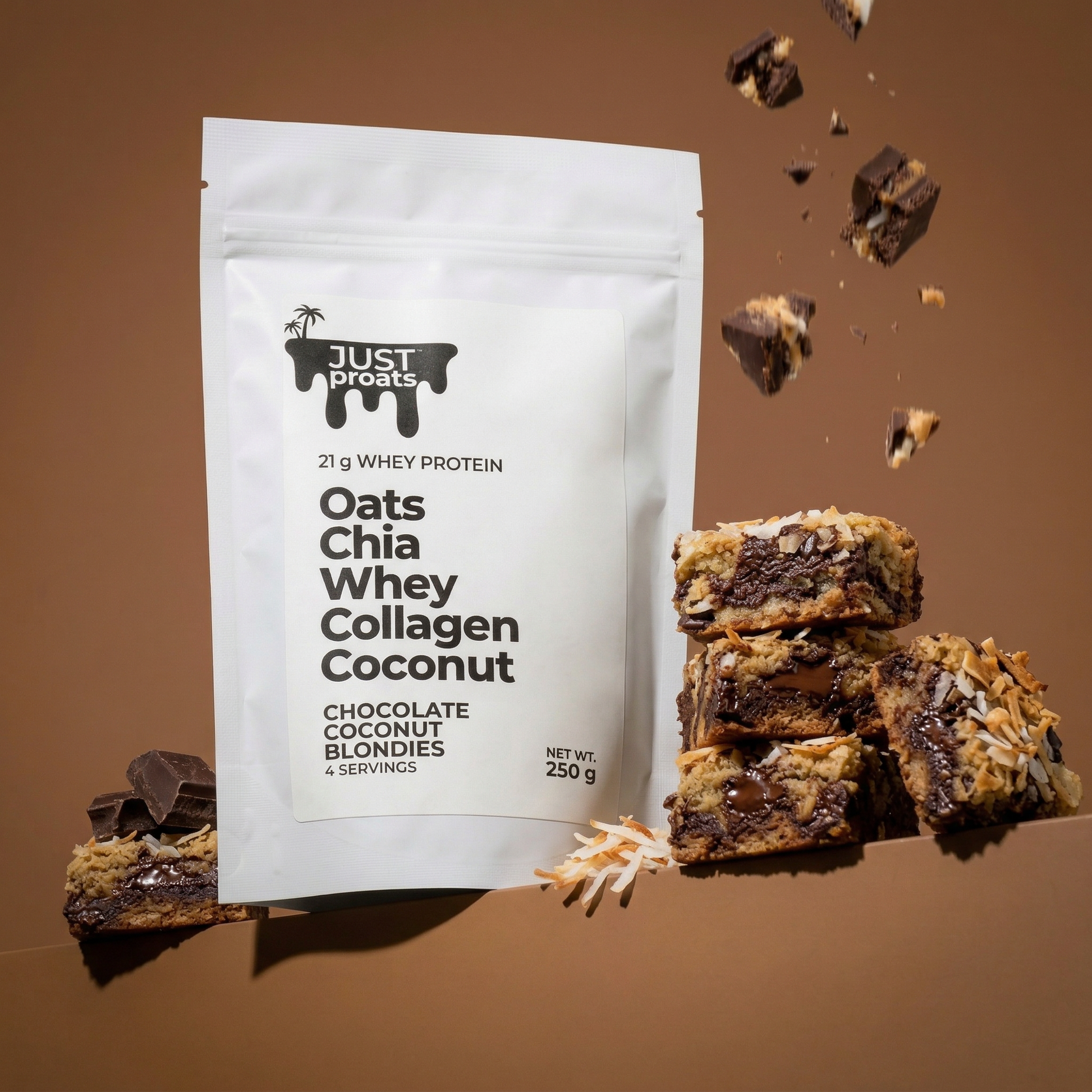 Just proats packaging with chocolate coconut blondies and chocolate pieces on a brown background