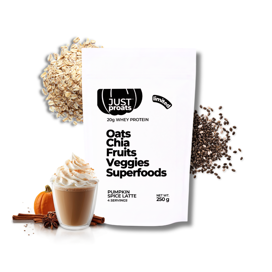 A white stand-up pouch of Just Proats Oats Chia Fruits Veggies Superfoods whey protein powder, styled with a pumpkin spice latte, oats, chia seeds, cinnamon, and star anise on a white background.