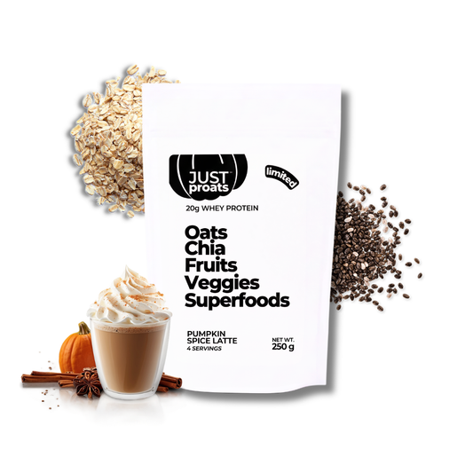 A white stand-up pouch of Just Proats Oats Chia Fruits Veggies Superfoods whey protein powder, styled with a pumpkin spice latte, oats, chia seeds, cinnamon, and star anise on a white background.