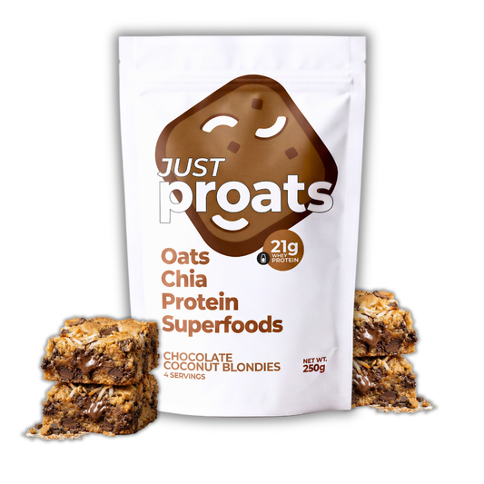 A white stand-up pouch of Just Proats Oats Chia Protein Superfoods Chocolate Coconut Blondies, shown with two stacked chocolate blondie bars on each side on a white background.