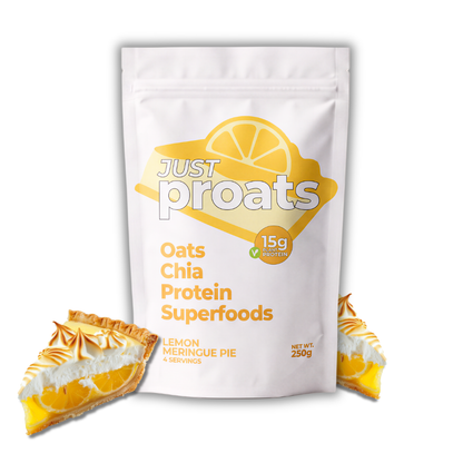A white stand-up pouch of Just Proats Oats Chia Protein Superfoods in Lemon Meringue Pie flavor, shown on a white background with two pie slices at the base.