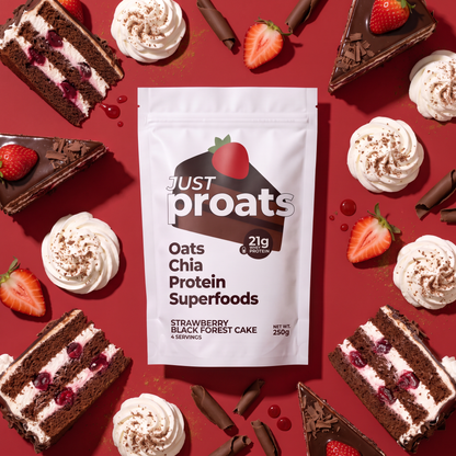 A stand-up pouch of Just Proats Oats Chia Protein Superfoods, Strawberry Black Forest Cake flavor, displayed on a red background surrounded by slices of chocolate cake, whipped cream, and fresh strawberries.